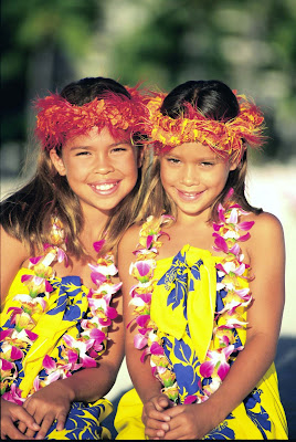 Two young girls with Haku lei on the  beach in Hawaii.