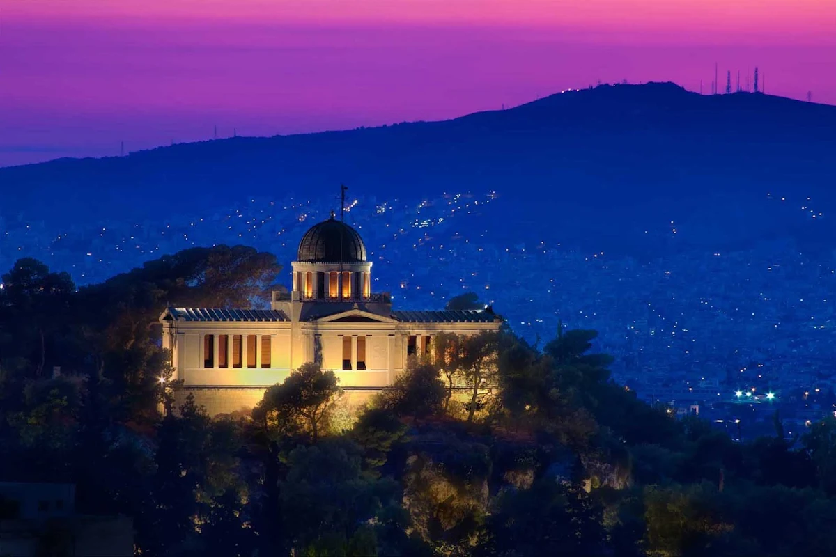 national-observatory-athens-greece - The National Observatory and surrounding hillsides at twilight in Athens, Greece.