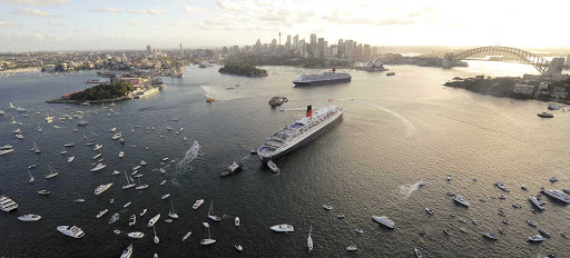 Sydney-Royal-Rendezvous - Queen Victoria and Queen Mary 2 have a royal rendezous as other vessels join in the celebration in Sydney Harbour.  Cunard is one of the leading cruise lines offering world cruises.