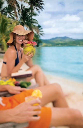 Sipping in the unspoiled beauty of Paul Gauguin's private beach on Motu Mahana.