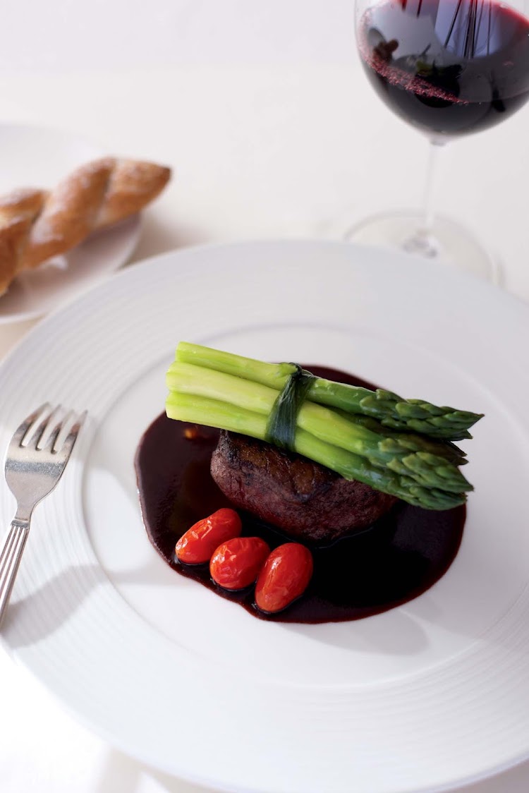 Steak is paired with tomatoes and asparagus for a main entrée aboard Crystal Serenity.
