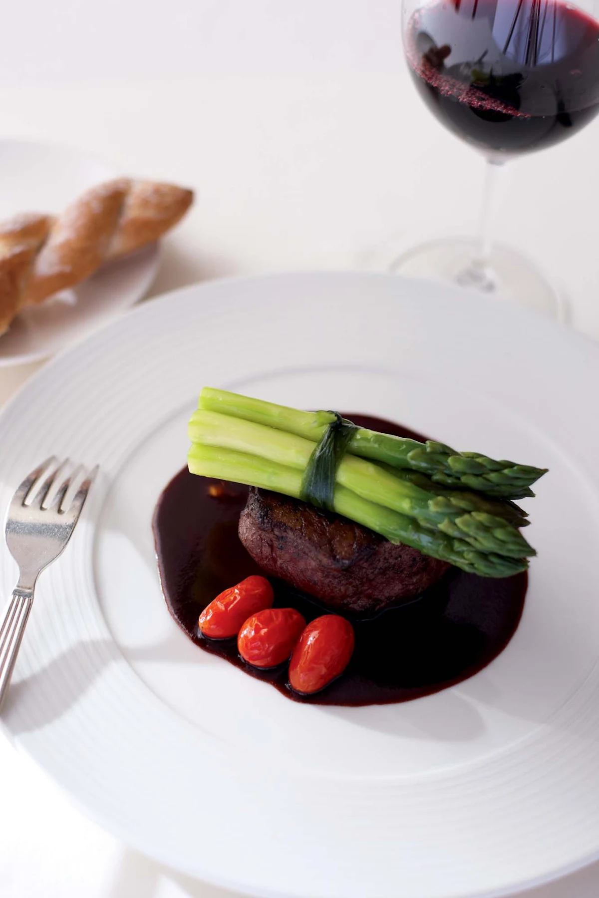 Culinary-Experiences-Steak-Dinner-Entree-1 - Steak is paired with tomatoes and asparagus for a main entrée aboard Crystal Serenity.