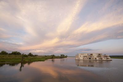 Day breaks over AmaWaterways' Zambezi Queen during her river safari on Africa's Chobe River. 