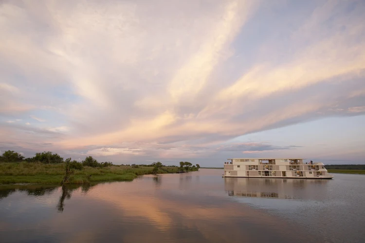 Day breaks over AmaWaterways' Zambezi Queen during her river safari on Africa's Chobe River. 