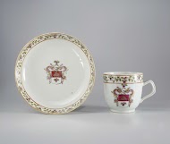 Cup with handle and saucer with a coat of arms and a monogram