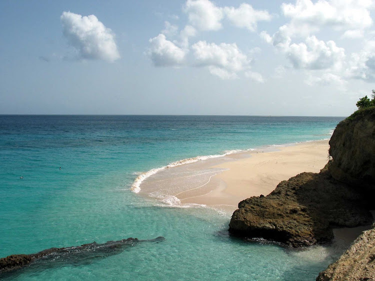 Beach meets the sparkling waters of Anguilla. Travelers visit for its natural beauty, quiet atmosphere and 33 pristine beaches. 