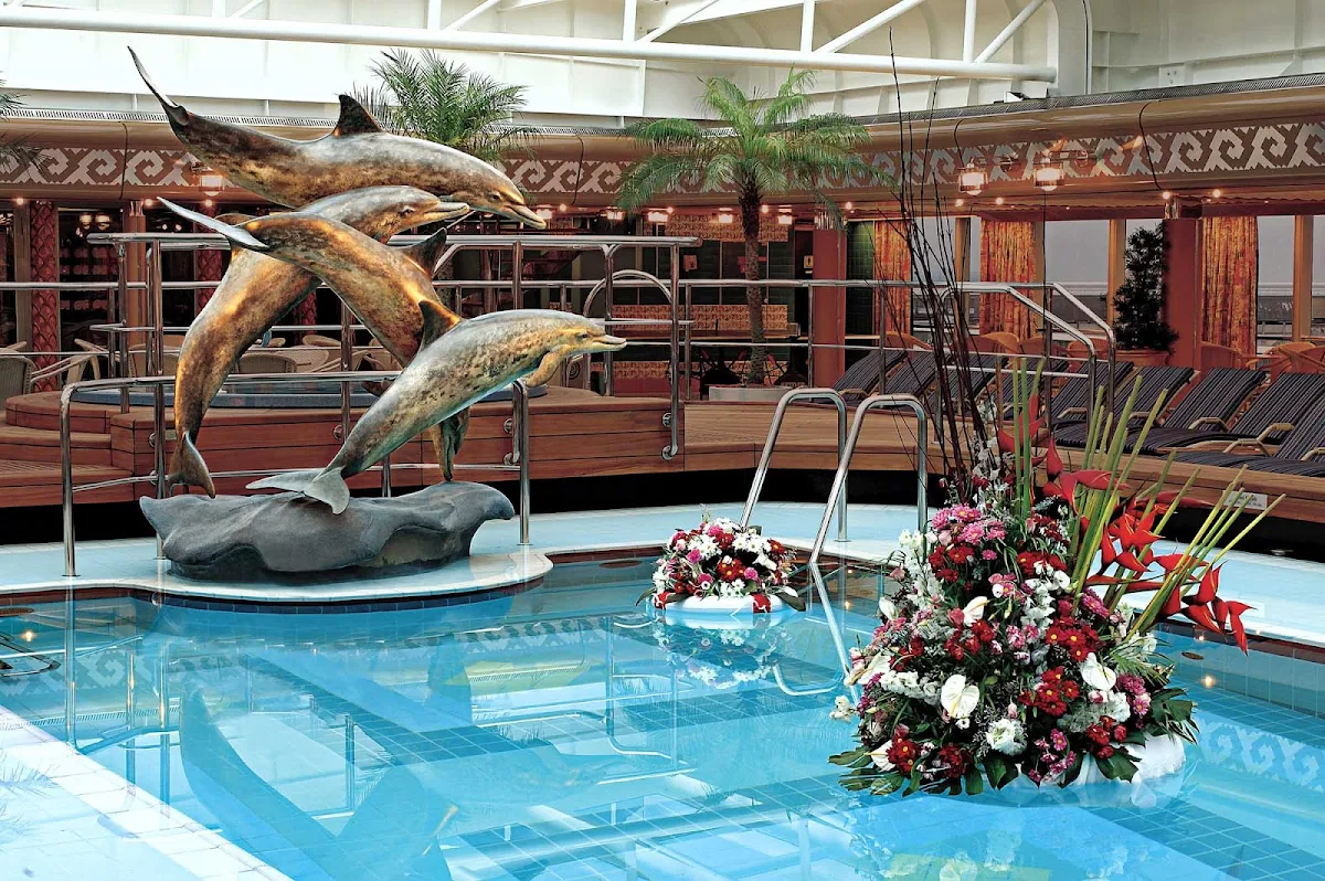Holland-America-Vista-Class-Lido-Pool-Midship - The sculptural figure of dolphins at the Lido Pool aboard Holland America's Westerdam, Noordam, Oosterdam and Zuiderdam. 