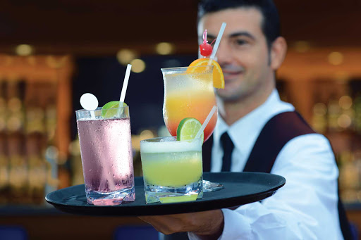 Get your evening started with a colorful tropical drink in Oceania Riviera's Waves bar.
