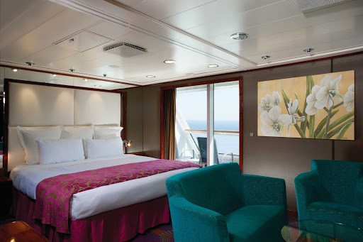 The spacious main bedroom of Norwegian Cruise Line's Pride of America's 2-bedroom Deluxe Family Suite is connected to a private balcony.