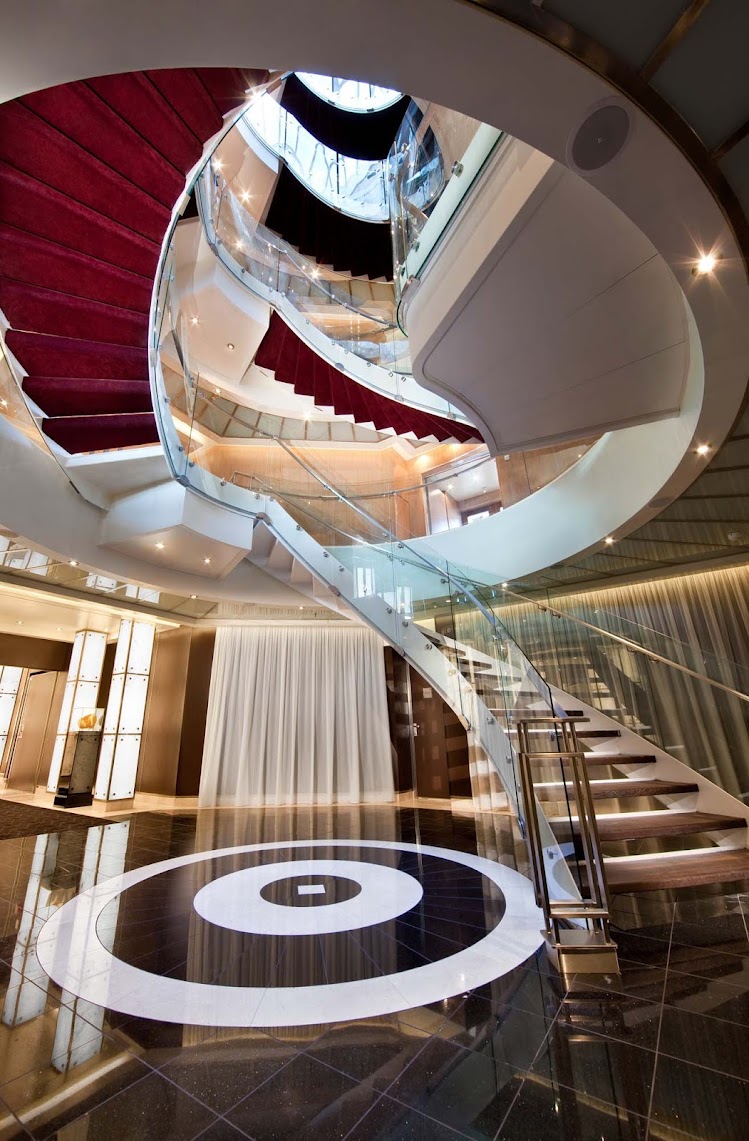 The Atrium staircase showcases the style and elegance you'll find aboard Seabourn Odyssey.