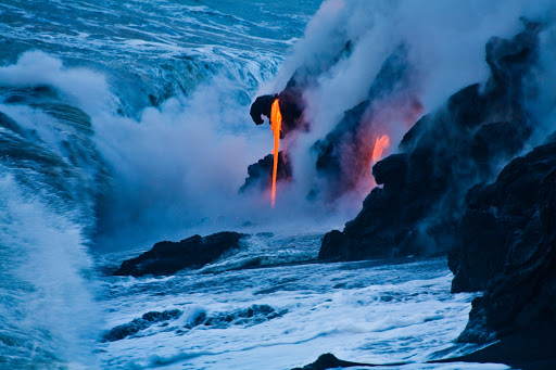 Hawaii-Big-Island-lava-flow-2 - Blue and orange converge as lava enters the sea at dusk at Pahoa on the Big Island of Hawaii. 