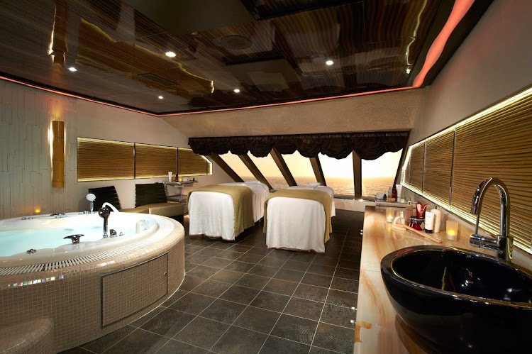 Indulge in some luxury with a friend at Cloud 9 Spa's couples treatment suite, a floating resort on Carnival Magic.