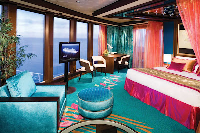 Floor-to-ceiling windows in the Deluxe Owner's Suite on Norwegian Gem give you perfect views of the ocean and sky. 