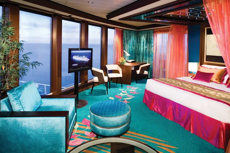 Floor-to-ceiling windows in the Deluxe Owner's Suite on Norwegian Gem give you perfect views of the ocean and sky. 