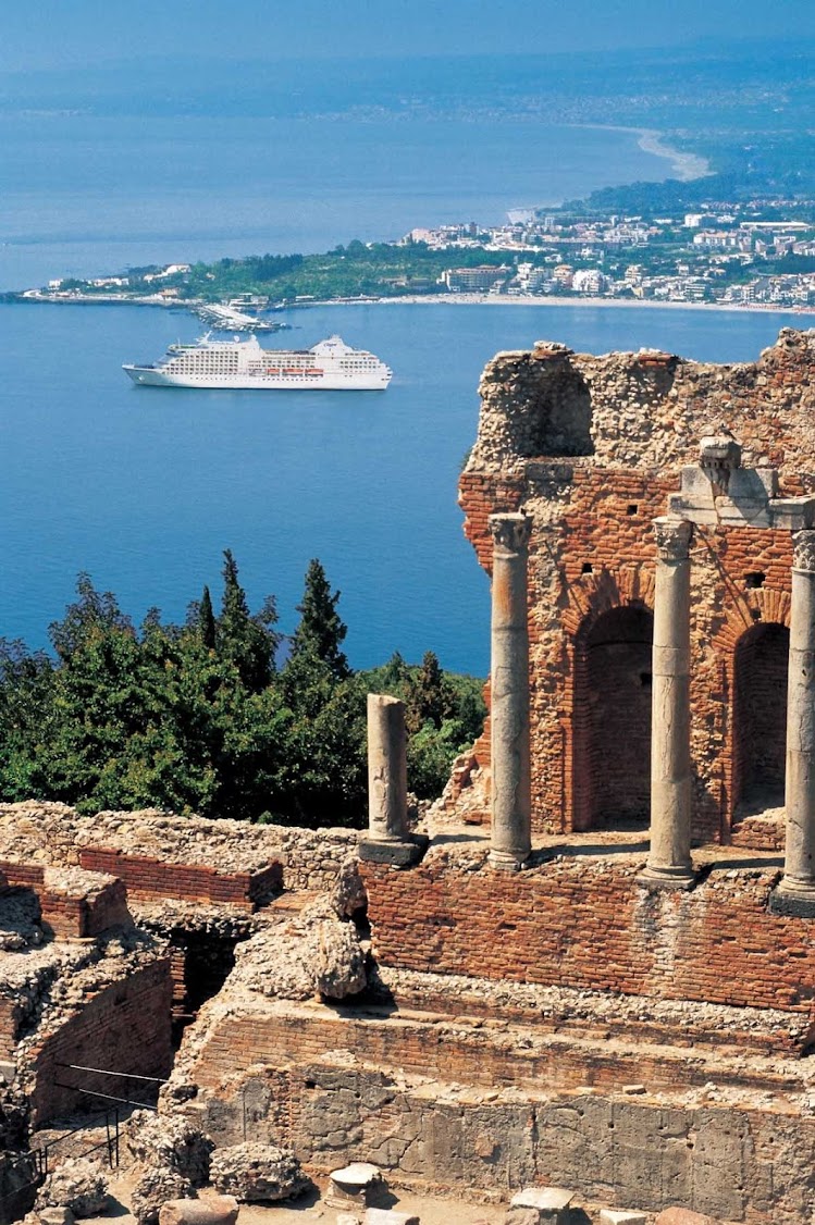 Travel on Regent Seven Seas and explore ancient Greek ruins perched on a hillside during a shore excursion to Taormina, Silicy.