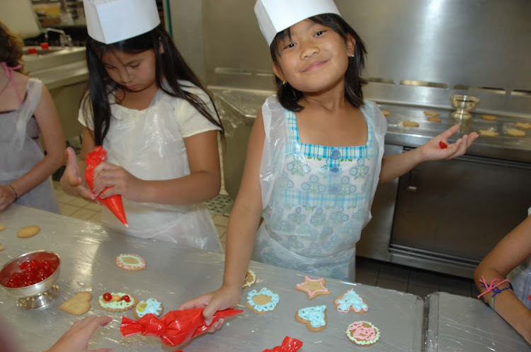 Take kids to the Galley to try their hand at pastry decorating, one of the Junior Cruisers activities aboard a Crystal cruise.