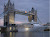 Silver Cloud passes under London's Tower Bridge at dusk.