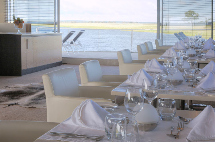 Take in scenic views from the dining room aboard AmaWaterways' Zambezi Queen.