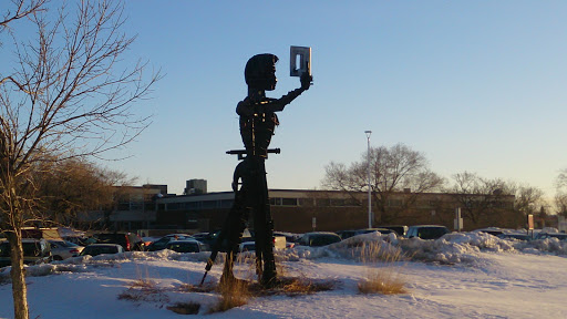 Metal Statue of a Man Reading