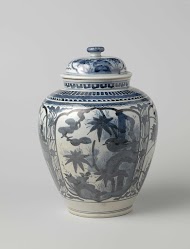 Ovoid covered jar with flowering plants in panels and ornamental borders