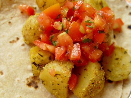 delicious baked potatoes with fresh tomato salad on chapati