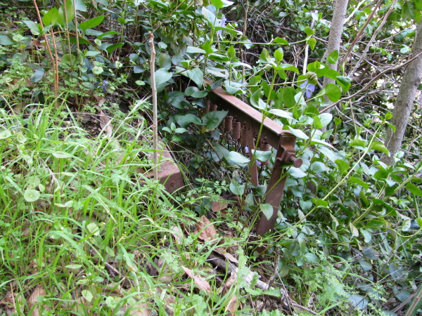 A cot folded by some force of nature and buried.