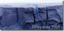 blue ice crevasses in tabular iceberg