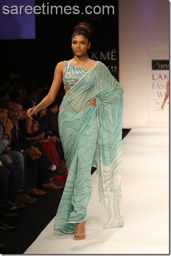 Model showcasing designer Satya Paul's sari paired with designer sari blouse
