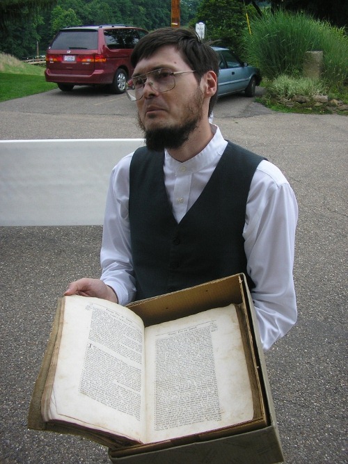 [Seth Hinshaw displaying an old Quaker text[5].jpg]