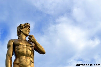 Statue of David set against a blue sky. Located at Baywalk along Times Beach shoreline.