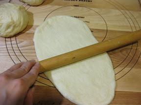 step by step photo showing how to roll the dough ball into an oval shape