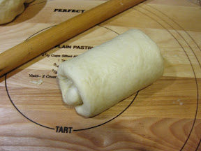 step by step photo showing what the rolled dough looks like before it goes in the baking pan