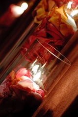 Rose petal filled vases and floating candles