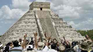 Villagers and tourists celebrate next to the Kukulkan pyramid at the Mayan ruins of Chichen Itza in Mexico's Yucatan peninsula (Source: Victor Ruiz/Reuters)