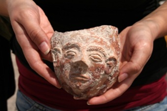 A sculpted face of a woman that was part of a cultic cup