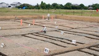 Researchers examine Thursday what is believed to be remains of the oldest structure used for an Imperial accession ceremony, in Kashihara, Nara Prefecture.