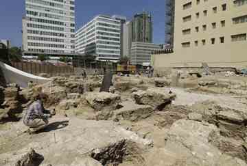 An archaeologist checks a ceramic found at an excavation site in central Beirut.
