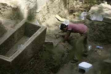 An archaeologist clears dirt around a Roman-era skeleton found at an excavation site in central Beirut.