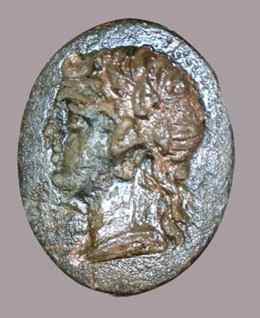 Bronze signet ring with portrait of Apollo. (Microscope photo adapted by Paula Weimann Barak, Courtesy of the Tel Dor Expedition)