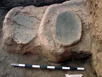 Clay installation encasing two grindstones in kitchen tract; date: ca. 3,500 B.C. 