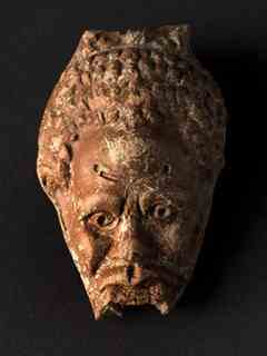 Reservoir of an anthropomorphic oil lamp, with Nubian head. - Image Copyright Hervé Paitier INRAP
