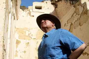 Dr. Zahi Hawass examines the entrance of Rudj-Ka's tomb [Photo: Meghan E. Strong]