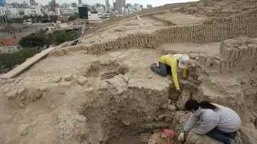Archaeologist Gladys Paz, bottom, and an unidentified man work at the site where a tomb from the ancient Wari culture was discovered in a pyramid called Huaca Pucllana in Lima, Peru. Picture: AP Photo/Karel Navarro  Source: AP