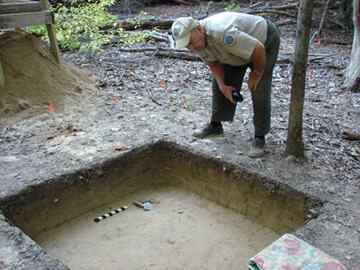Jerome Traver looks over a portion of centuries old home discovered at York River State Park.