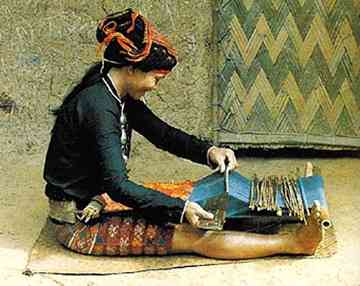 Weaver with a  backstrap loom in Hainan Province. Jili Nationality. 