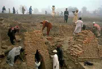 Workers excavate a culvert at the circa-2725 B.C. site of the Harappa settlement in Pakistan (Photograph by Randy Olson, National Geographic).