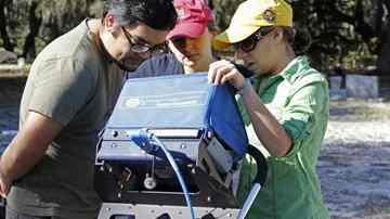 Alejanbro Figueroa, left, Whitney Goodwin and Aliceia Alfaro check the monitor on the ground penetrating radar Saturday at Samford Cemetery in Riverview. 