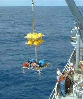 Researchers recovered fluids from beneath the seafloor using specialized deep-sea sampling platforms, shown above being deployed from a research vessel and below on-board the ship with UCSC ocean scientist Matt McCarthy.