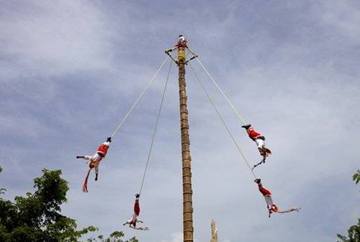 During the Danza de los Voladores de Papantla, four voladores (birdmen), one each for the gods of sun, wind, earth and water, swing from a rope tethered to their ankle around a pole as high as 100 feet and gradually descend to the ground. [Photo: Rui Vale de Sousa / Shutterstock]