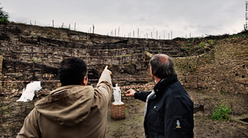 Archaeologists survey the twelve-metre long wall at the House of the Moralist.